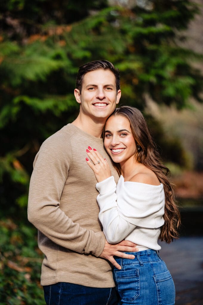 Man and woman share radiant grins as they gaze into the camera, brimming with happiness and warmth.