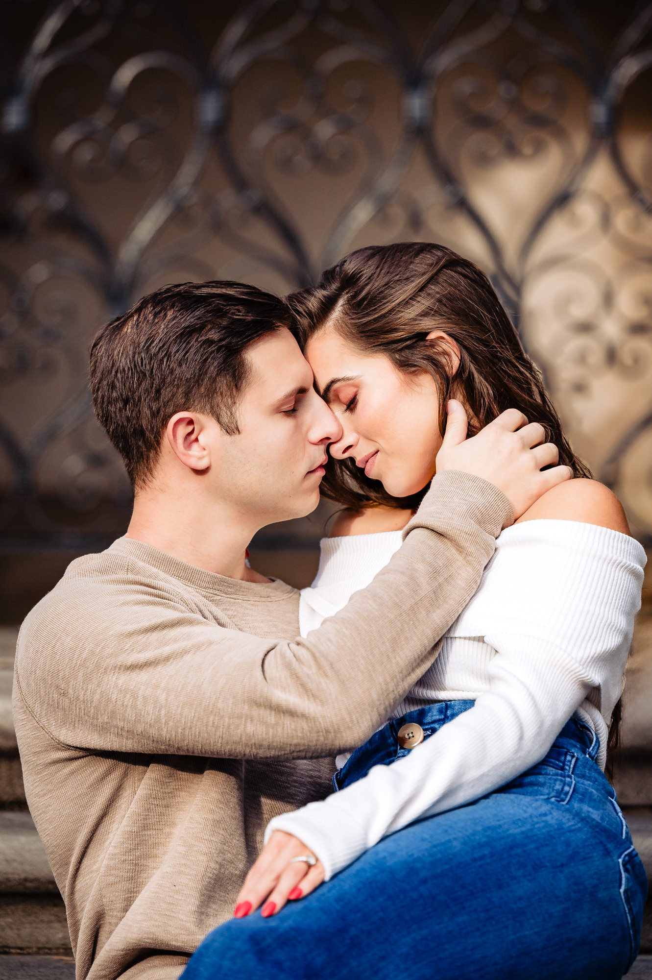 The engaged couple shares an intimate, heartfelt moment against the backdrop of a bold and striking concrete structure, celebrating their love.