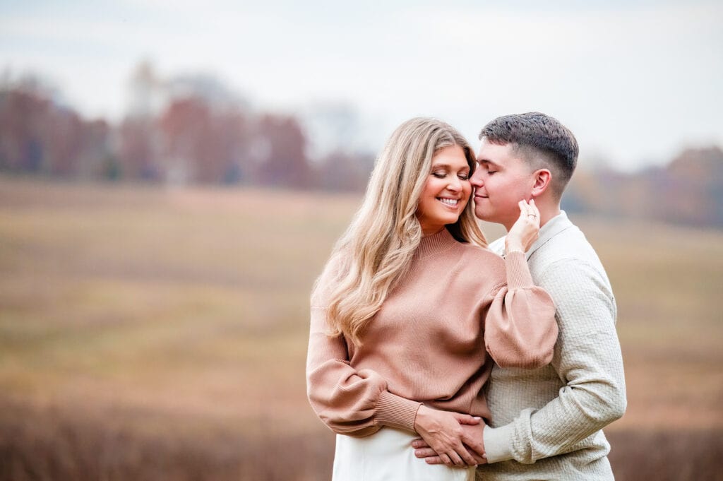 intimate moment between a couple as they pose for the camera at longwood gardens