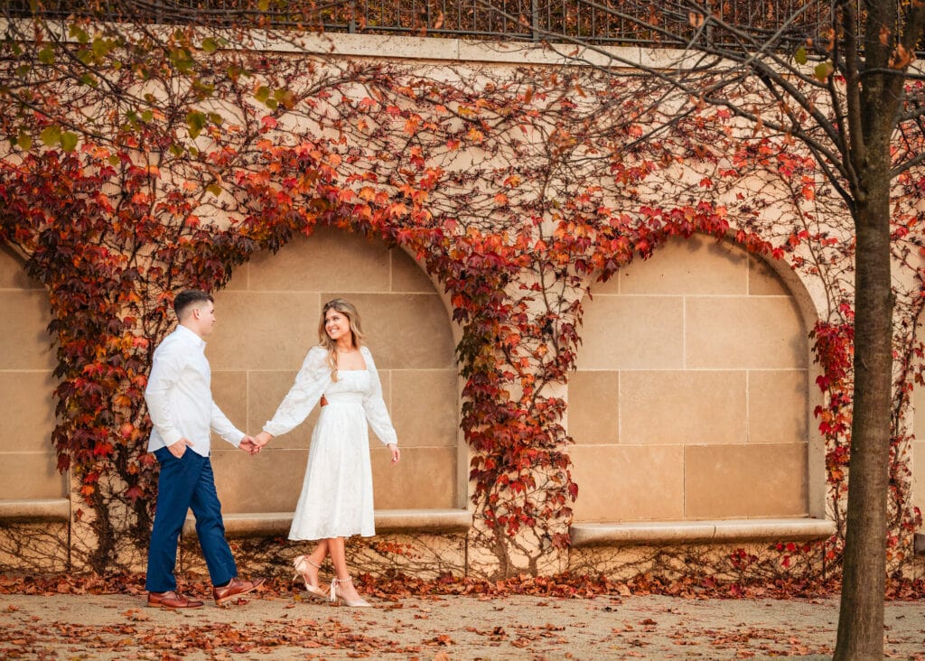 candid shot of woman holding the man hand and looking at him while walking