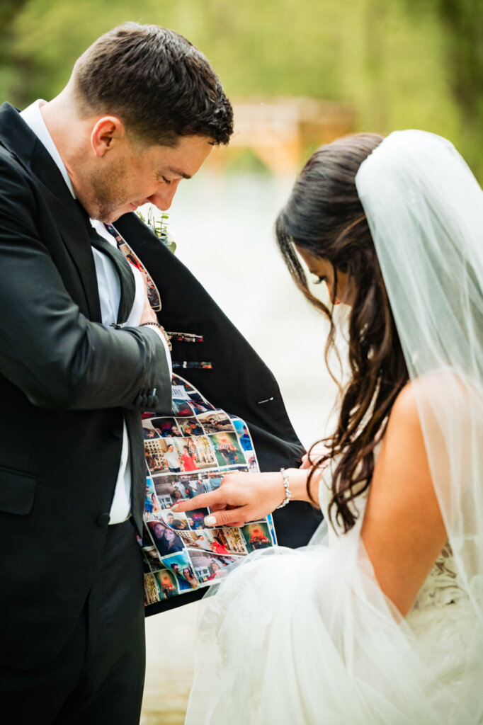 The groom proudly showcases his tuxedo, adorned with collage photos beneath, a personalized touch celebrating cherished memories on this special day.