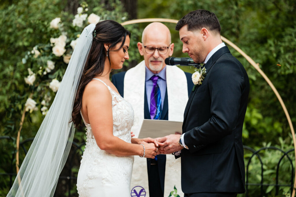 bride and groom stand amidst the beauty of a garden, exchanging heartfelt vows