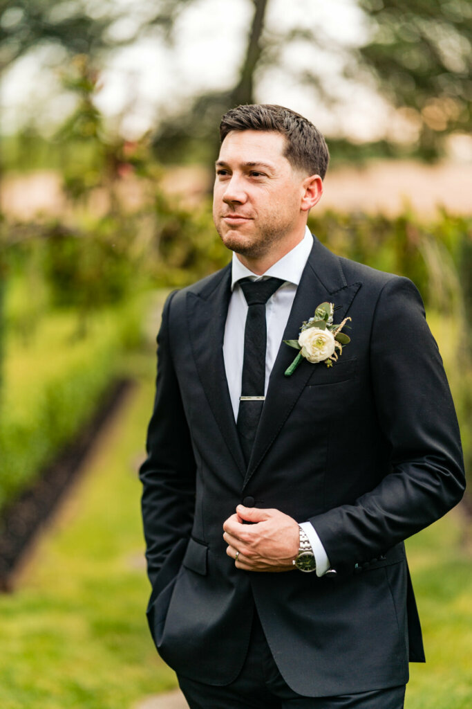 The groom awaits his bride with bated breath, anticipation etched on his face as he eagerly awaits the moment when she will walk down the aisle