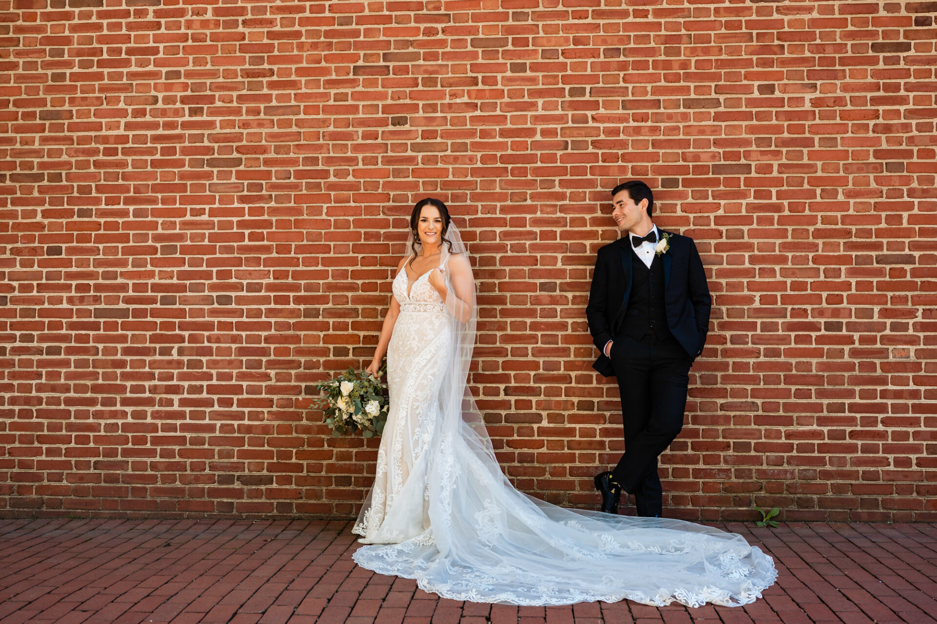 the groom smiles affectionately at his bride, his eyes filled with love and adoration