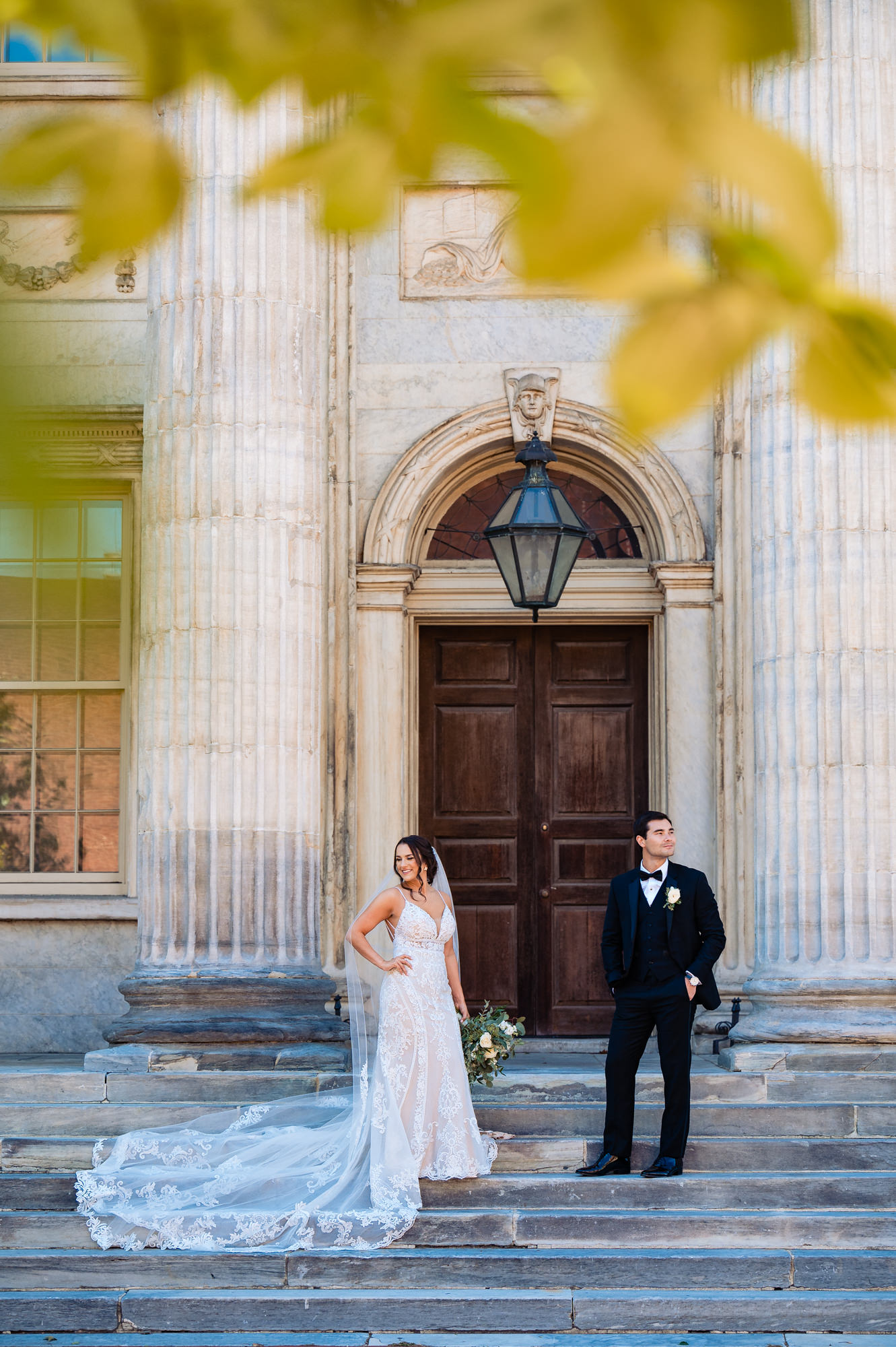 Against the majestic backdrop of towering columns at the First Bank of the United States, the groom and bride strike a pose by looking away from each other.
