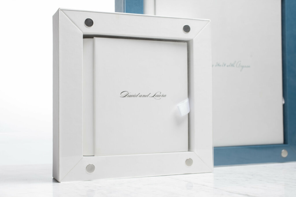 A pristine white box contains an elegant wedding album inside, the pure color palette creating a fresh, minimalist presentation.