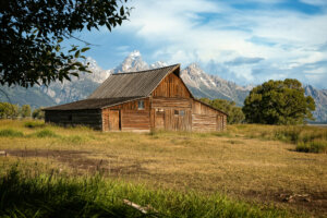 Moulton Barn, framed by the iconic Grand Teton mountains in the background, stands as one of the most photographed barns in America, symbolizing the rugged beauty and heritage of the American West