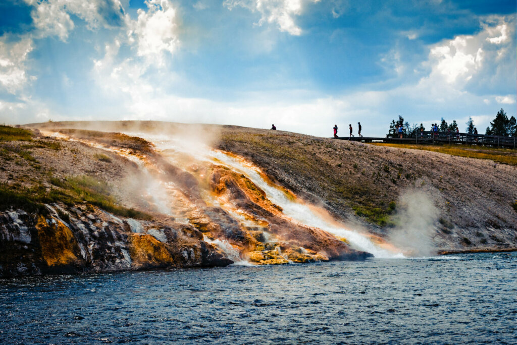 Amidst the geothermal activity at Yellowstone National Park lies the captivating Grand Prismatic Spring. Its dazzling waters display a stunning red hue that swirls among other vivid colors, leaving onlookers spellbound with the mesmerizing natural spectacle it offers at the core of the park.