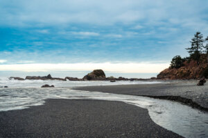 A tranquil shoreline at Kalaloch Beach, where gentle waves lap against the sandy shore
