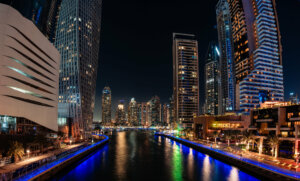 night shot of the scenic panorama of Dubai Marina, a modern waterfront destination bustling with activity and luxury.