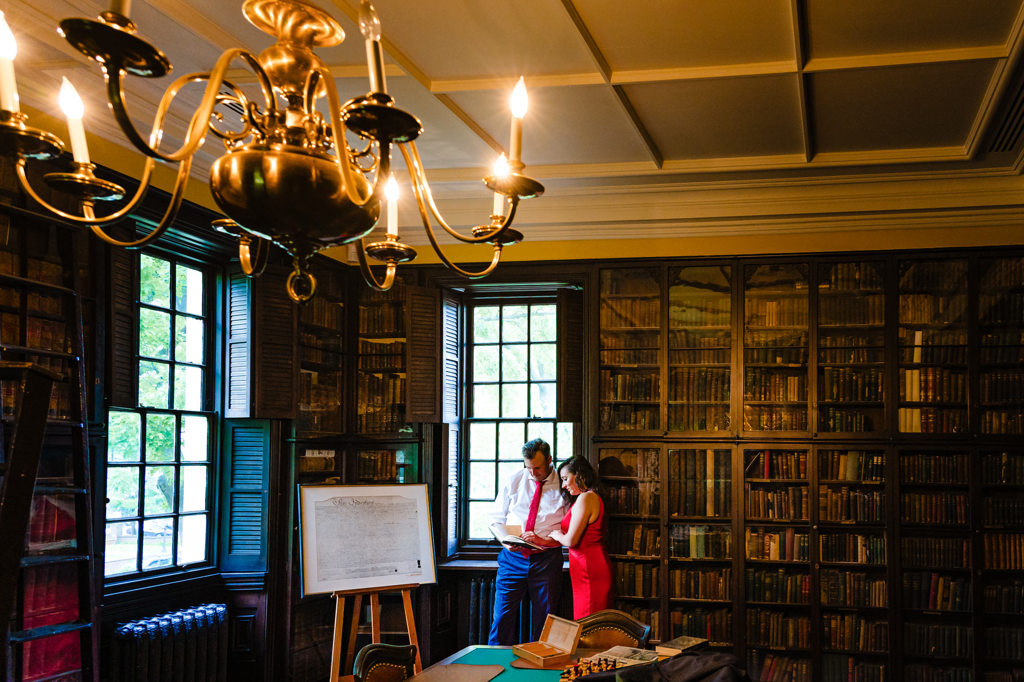 Capturing a romantic engagement photo in Carpenter's Hall's library.