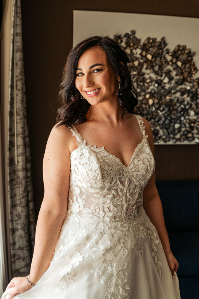 Radiant bride beaming with joy in her beautiful wedding gown.