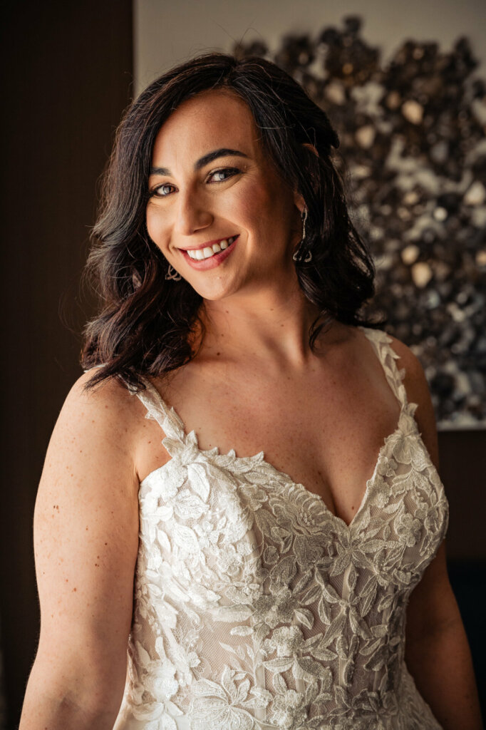 Bridal portrait of the bride smiling beautifully in her wedding gown