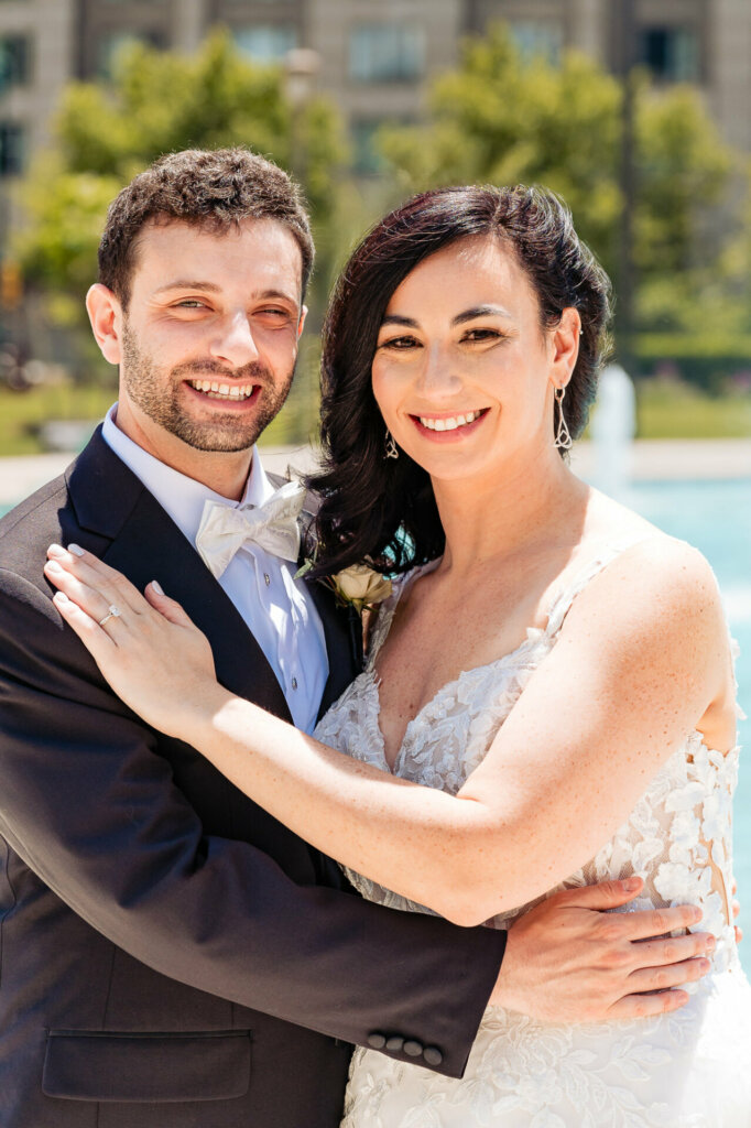 Happy newlyweds smiling warmly as they embrace in a loving portrait.