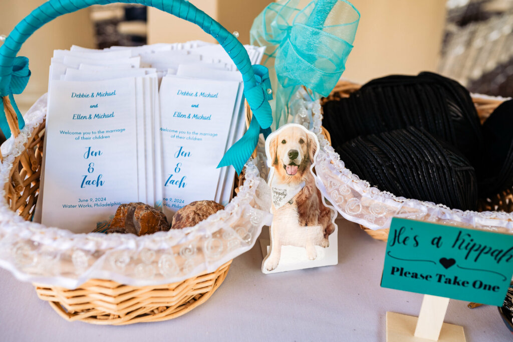 A whimsical cardboard cutout of a dog adds a touch of fun, while a woven basket displays the wedding menu and a kippah rests nearby