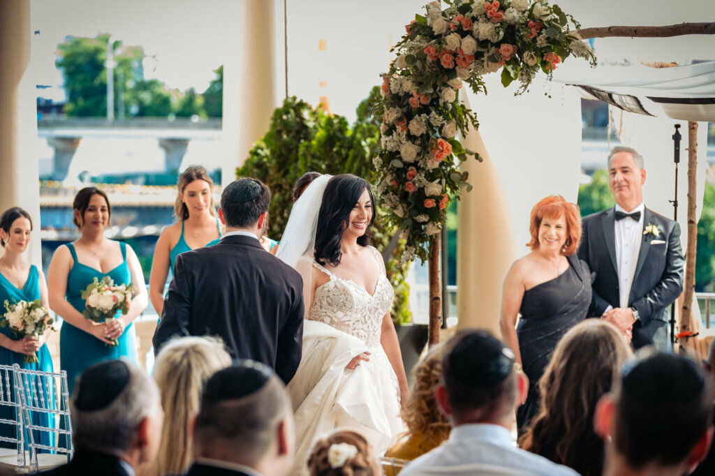 radiant bride smiles at the guests during the ceremony