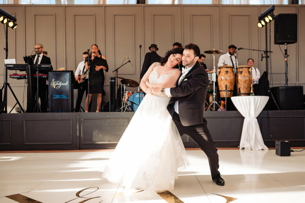Under the soft glow of fairy lights, the newlyweds dip into a slow dance. Their eyes meet, filled with a love that has culminated in this very moment.