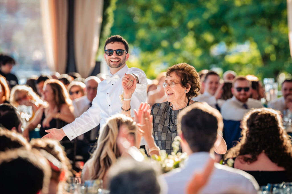 Groom gracefully twirling his mother during their joyful dance at the wedding reception.