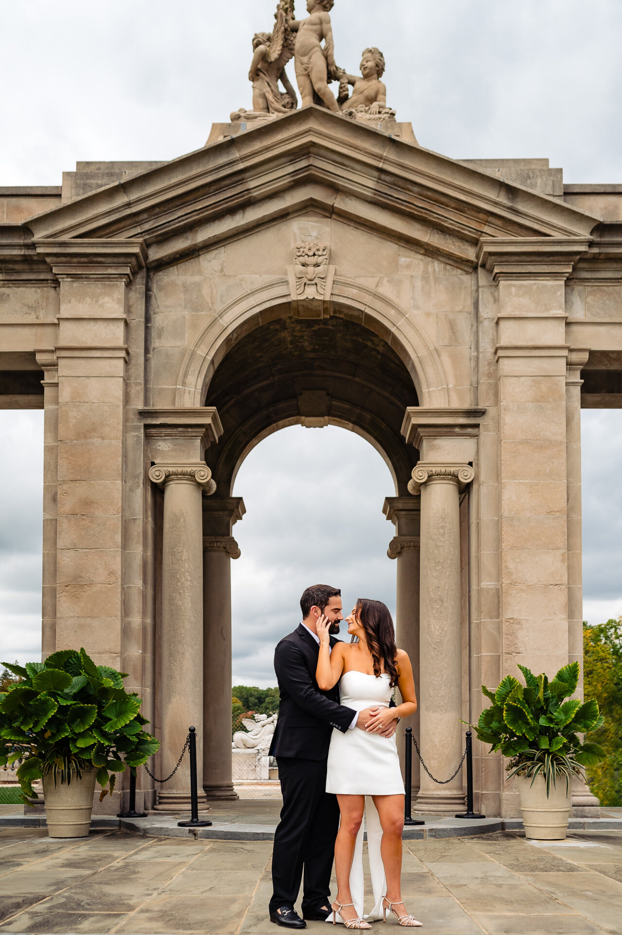 couple standing closely together in an outdoor setting during their engagement session