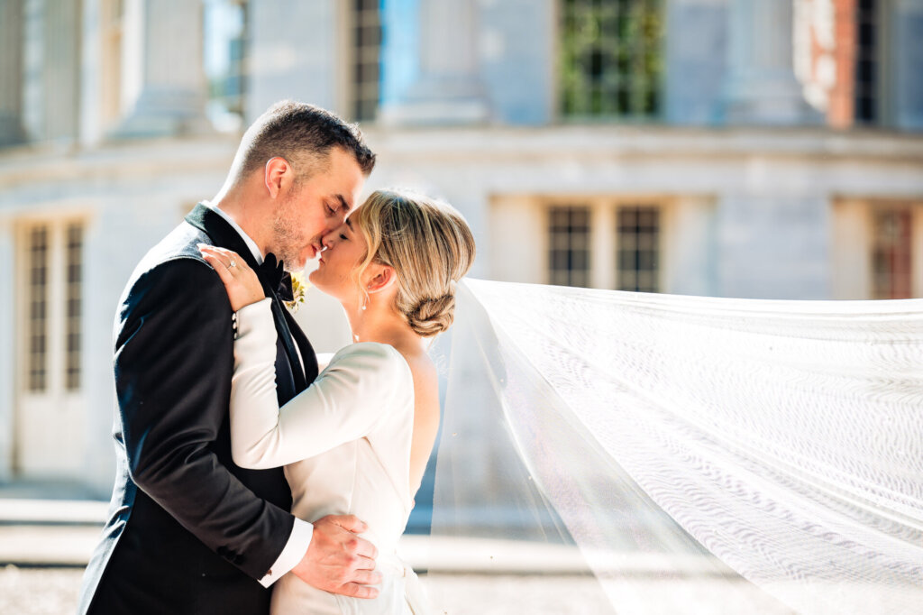Close-up shot of the bride and groom leaning in for a tender kiss.