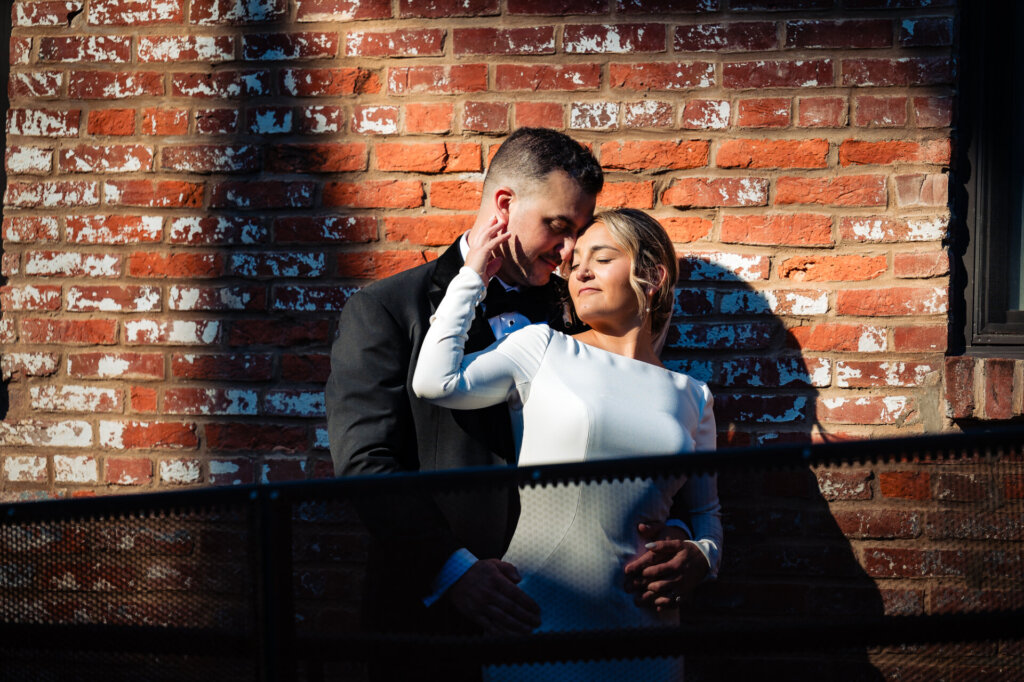 Bride and groom sharing a quiet, intimate moment as they hold each other close.