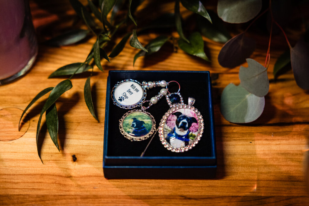 Close-up of custom keychains with a globe and a picture of the couple's dogs design, presented in a decorative box