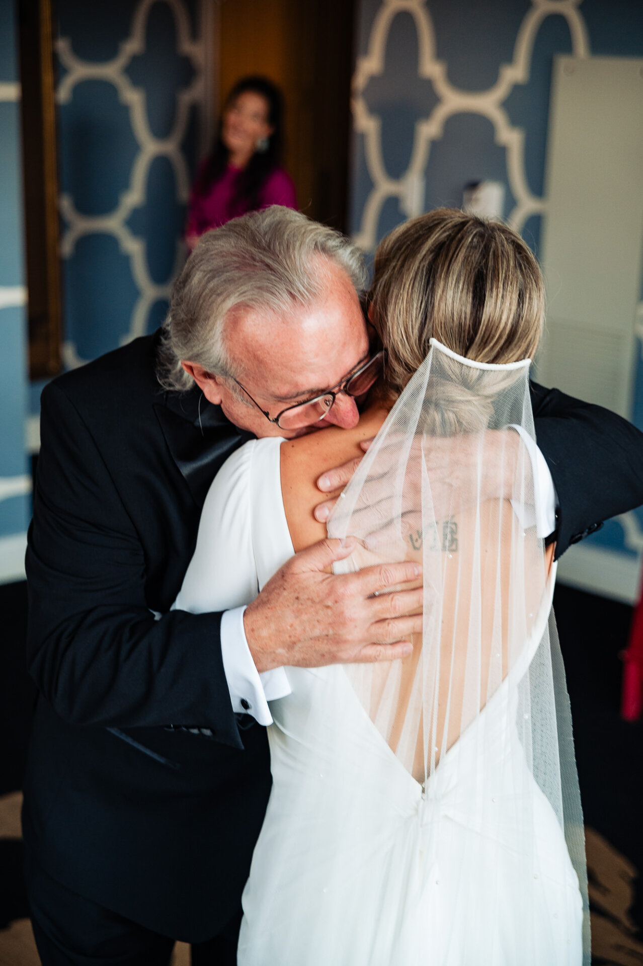 Bride's father embracing her in a heartfelt hug
