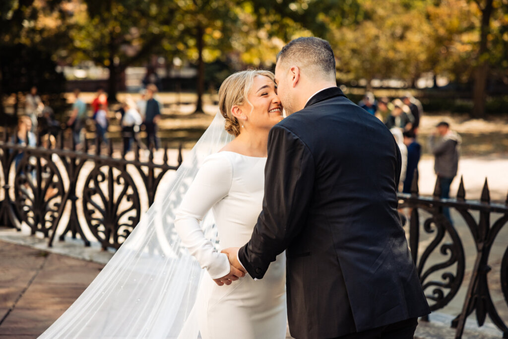 Bride and groom exchanging smiles and laughter during their emotional first look
