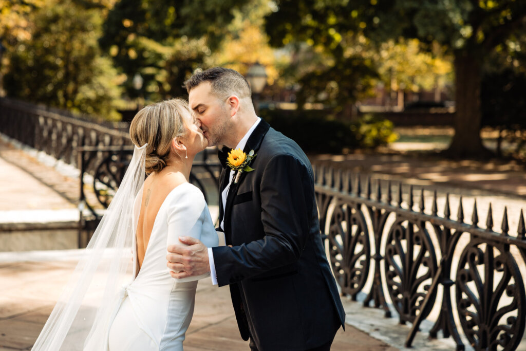 Bride and groom sharing a tender kiss after their emotional first look.