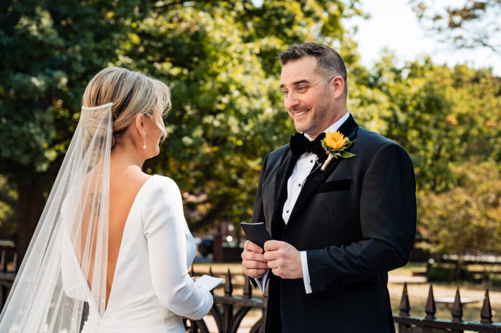 Groom smiling as he sees the bride for the first time in her wedding dress.