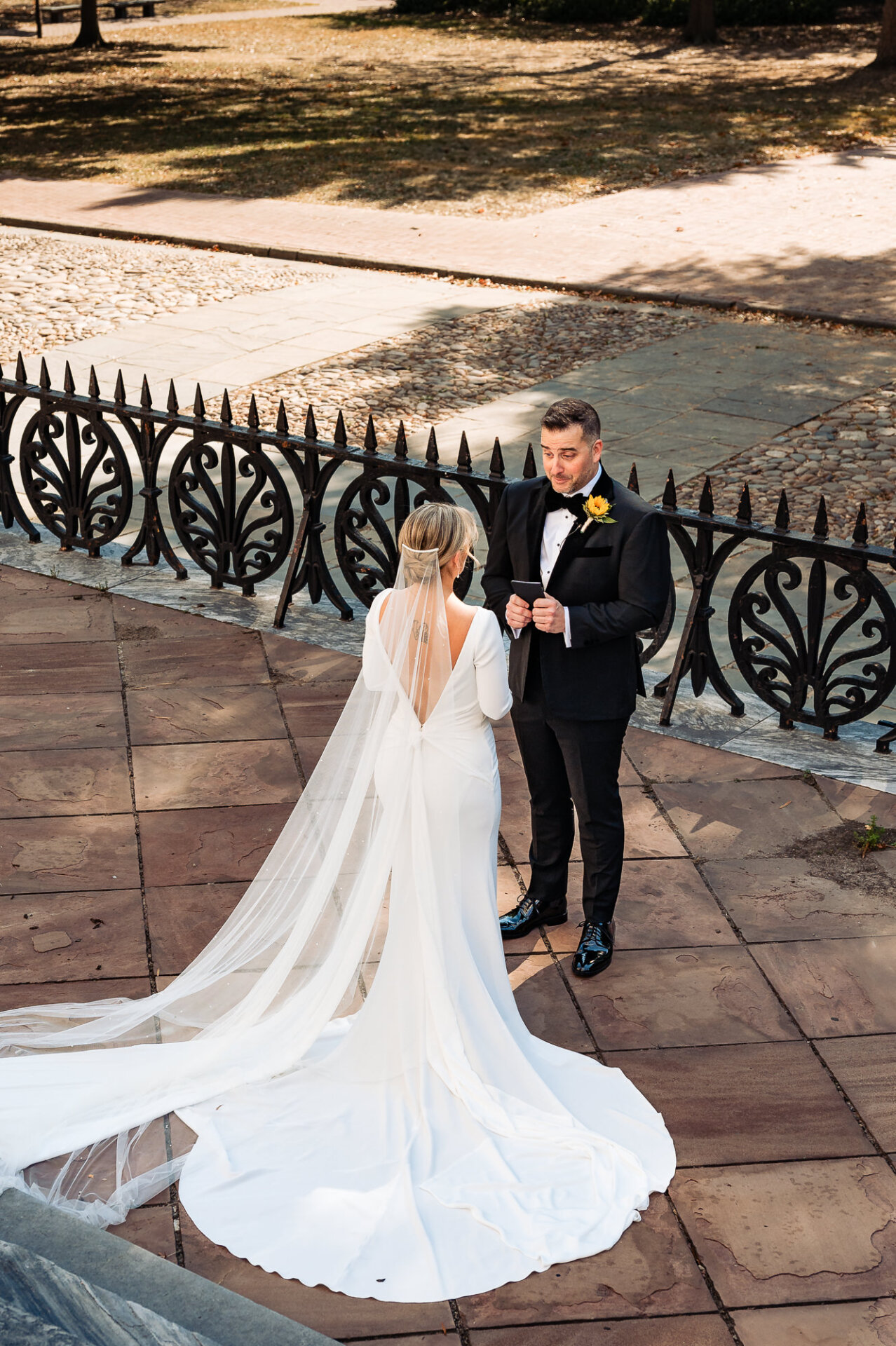 Groom holding back tears as he sees the bride for the first time in her wedding dress.