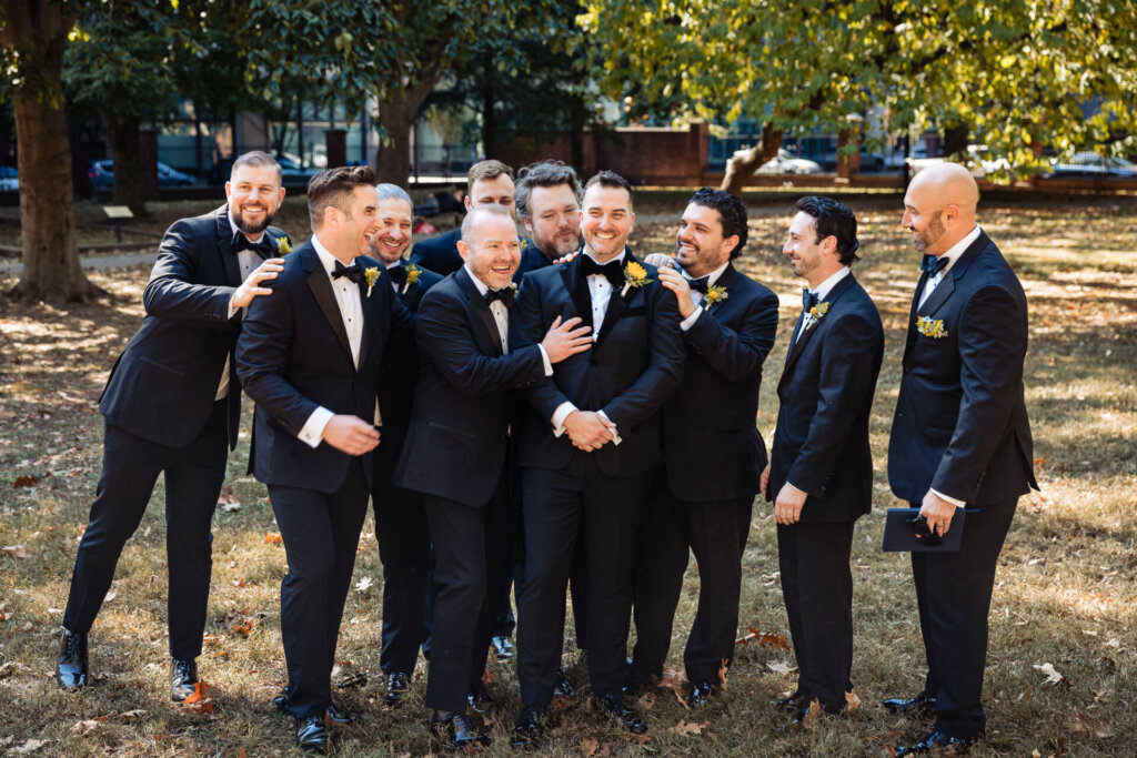 Shot of the groom and groomsmen laughing and enjoying a light-hearted moment together.