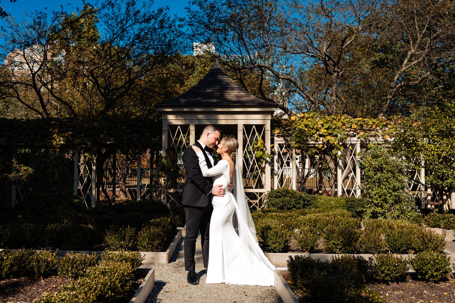 Bride and groom leaning their foreheads together, smiling in a tender and intimate moment.