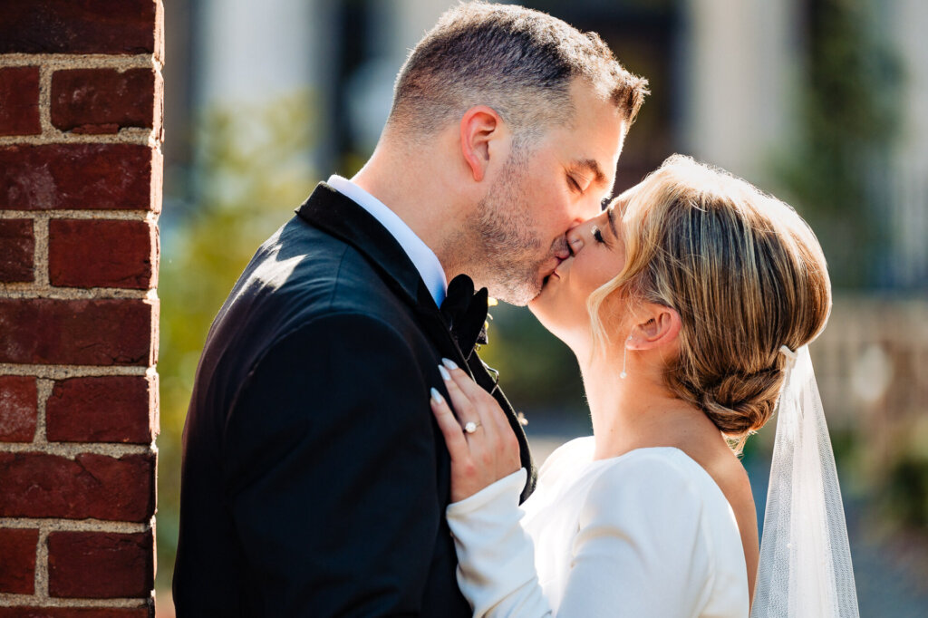 Close-up shot of the bride and groom sharing a tender kiss.