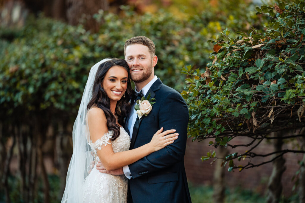 Bride and groom smiling warmly at the camera