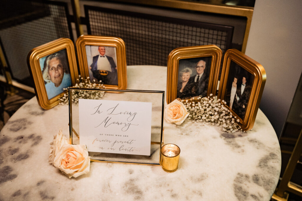 Photos with passed loved ones of the bride and groom with a sign saying 'A Living Memory'