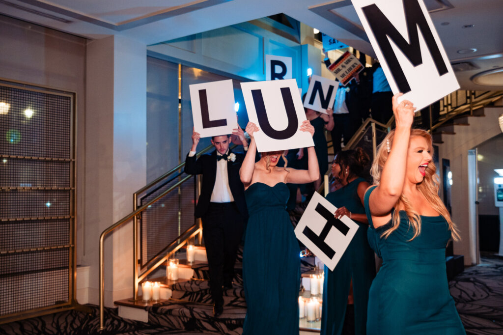The guests raising signs and partying going down the stairs