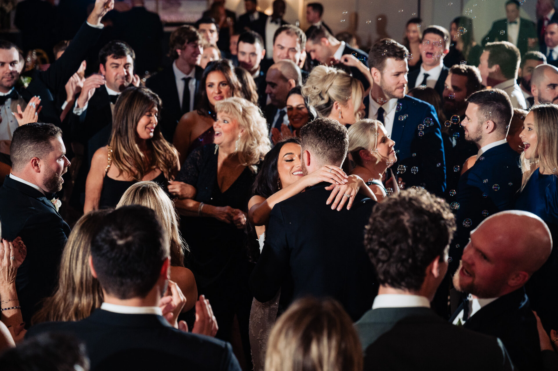 Bride and groom dancing together in the midst of the guests partying