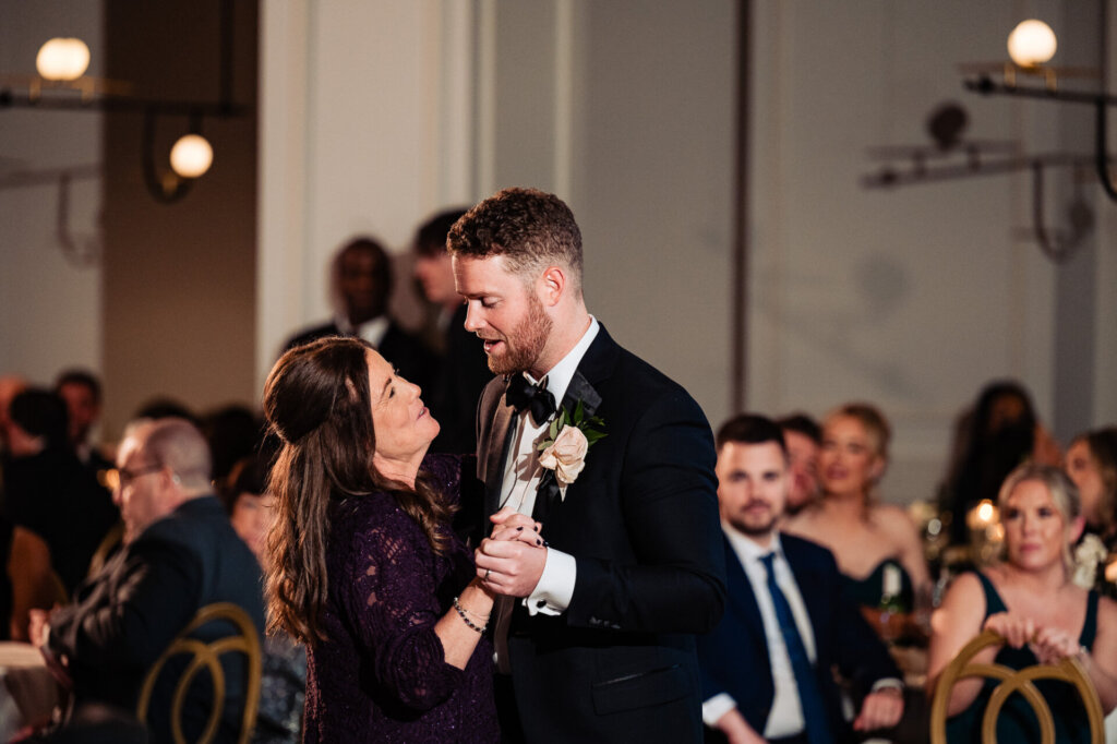 Close-up shot of the groom and his mother dancing