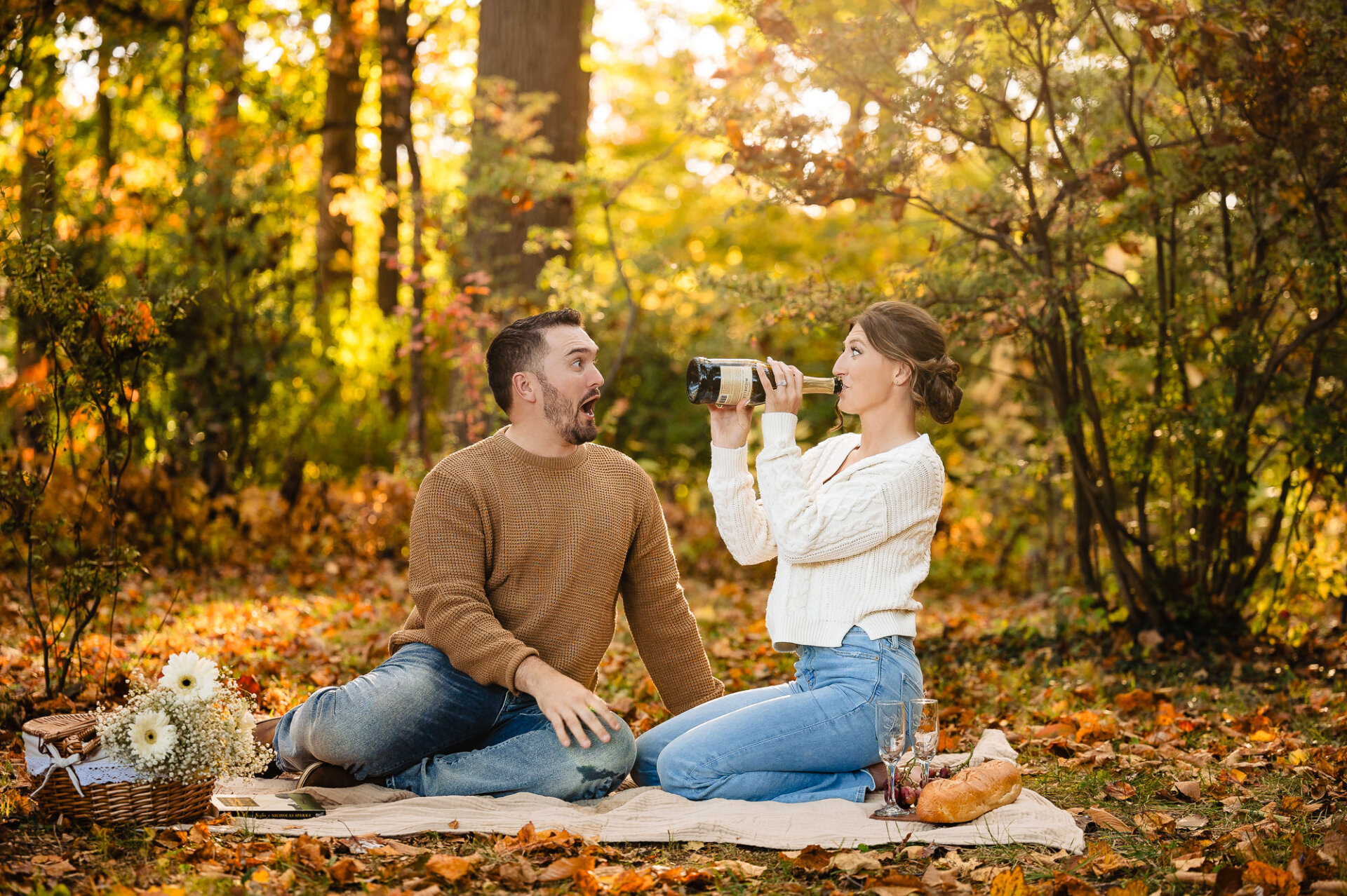 The woman playfully drinking from the bottle while the man makes a surprised in awe face