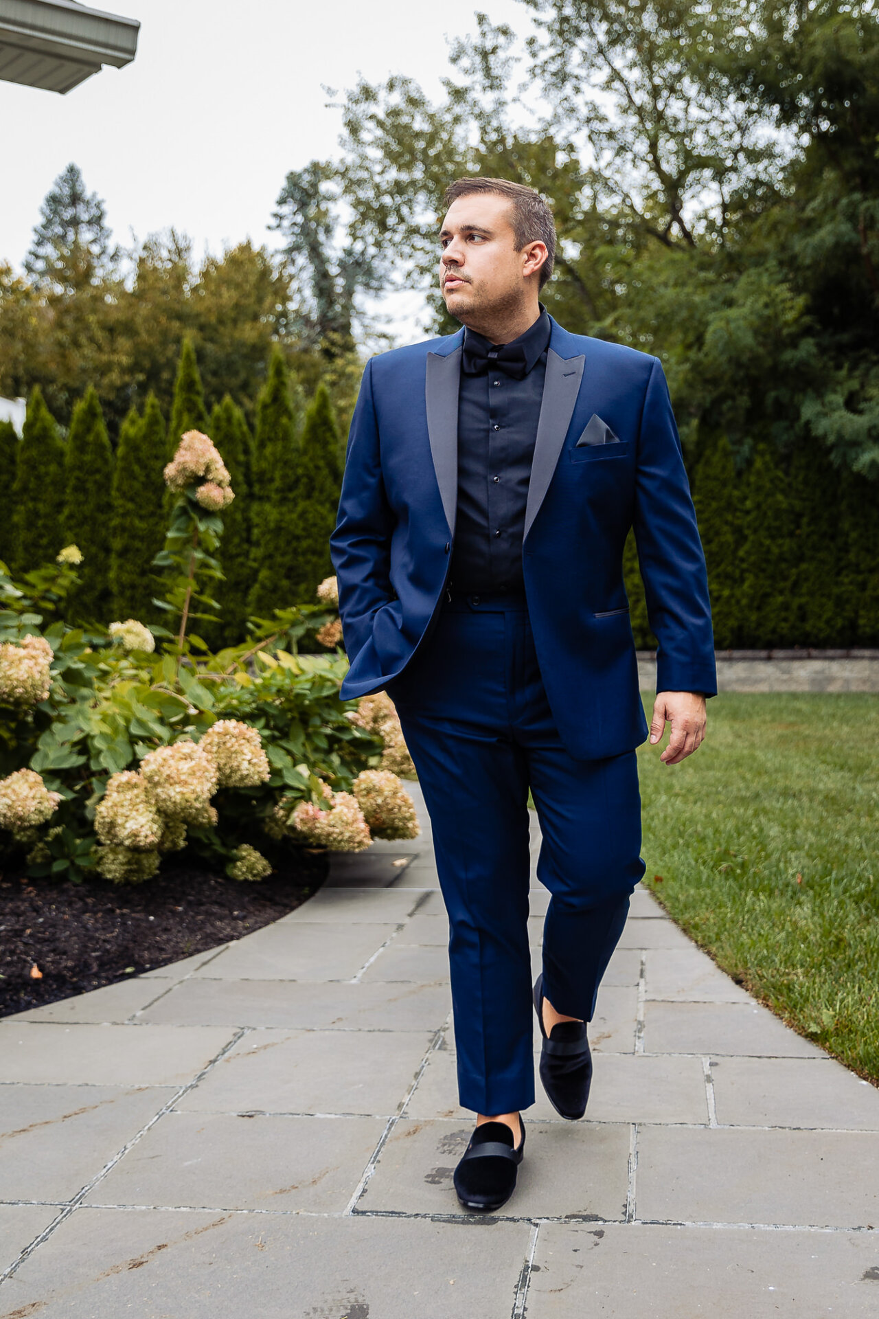 A candid moment capturing the groom in motion, preparing for the big day.