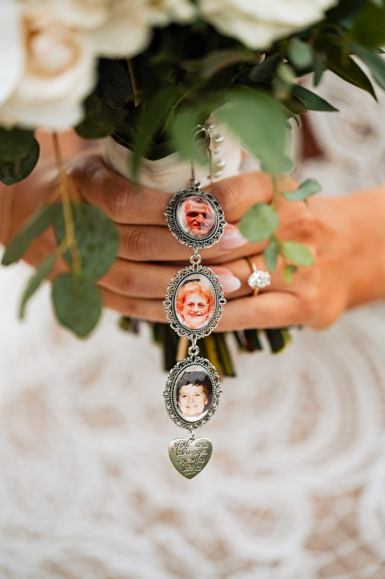 Small photo lockets attached to the bouquet, honoring loved ones.