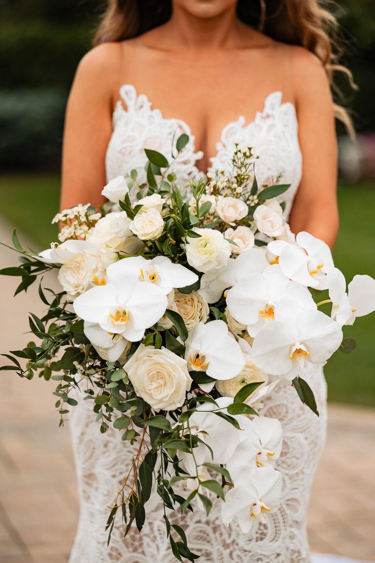 A close-up of the bride’s bouquet, featuring lush florals and greenery.