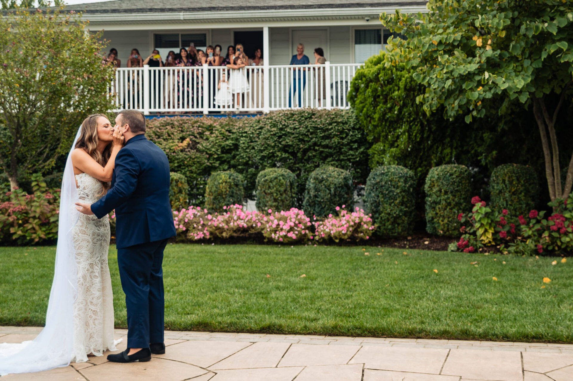 Friends and family look down at the couple, enjoying a joyful pre-wedding moment.