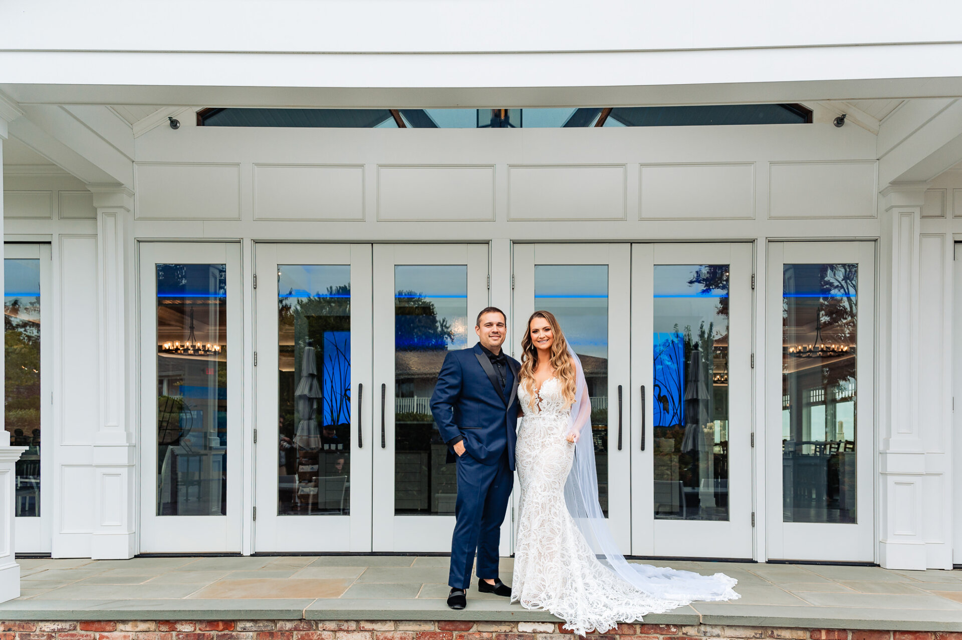 Bride and groom posing and smiling at the camera during their Crystal Point Yacht Club Wedding