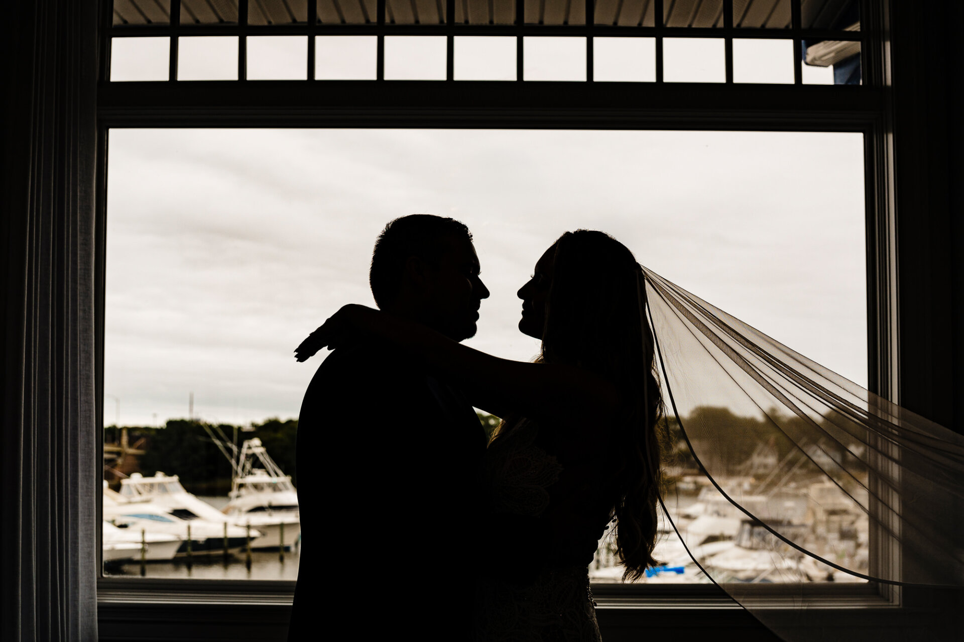 A silhouette shot of the bride and groom holding each other