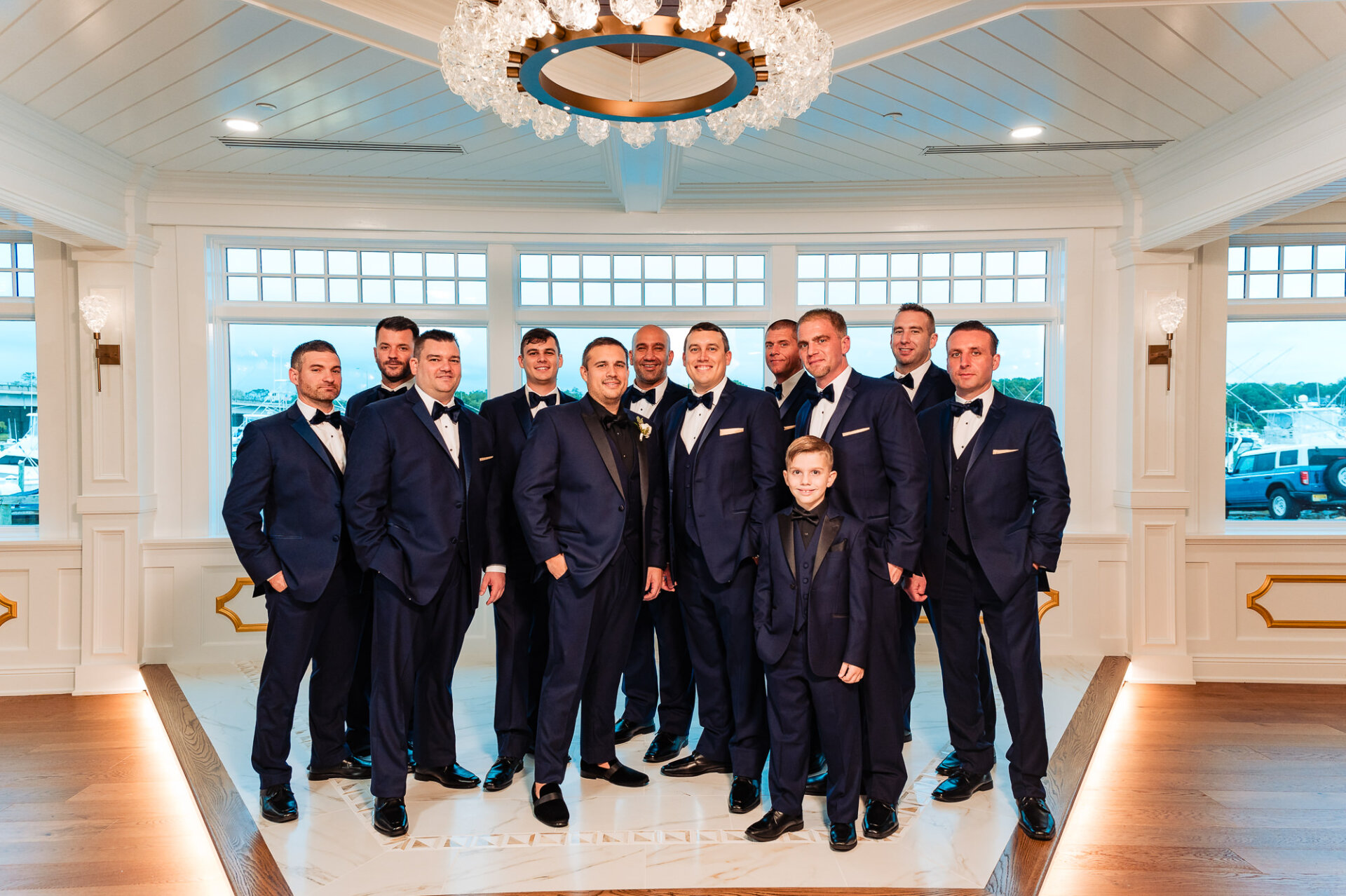 Groomsmen in navy suits standing together in a formal pose – A classic portrait of the groom and his best men.