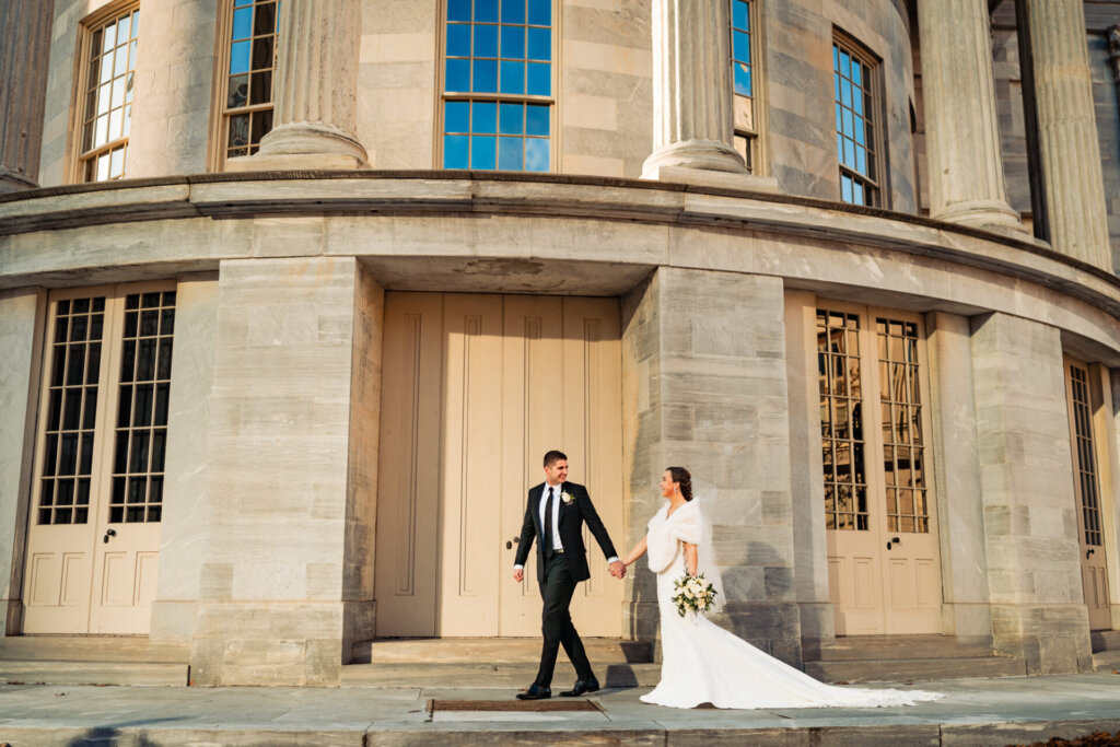 A cinematic shot of the newlyweds moving together, with the bride’s train flowing behind her.