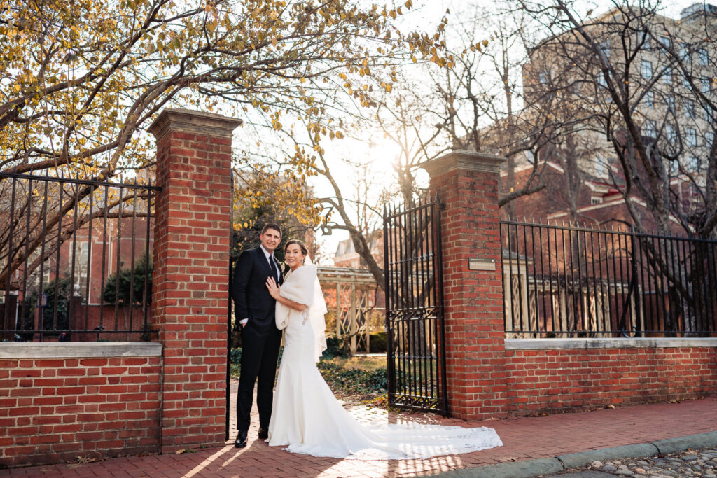 A scenic moment as they stand together in a sunlit garden.