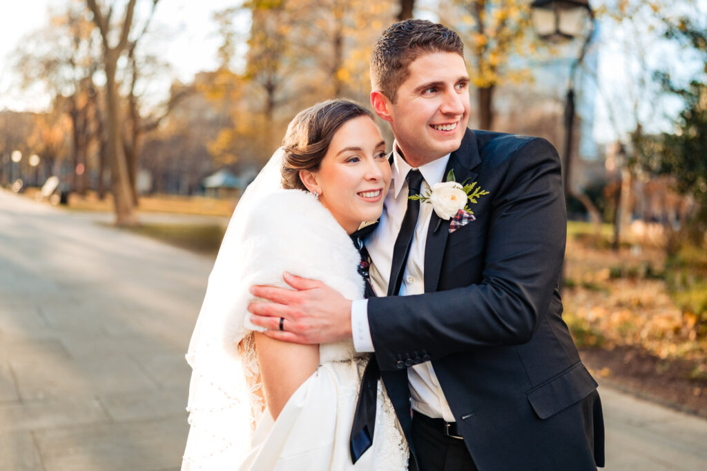 golden hour portrait as the couple gazes into the distance with soft light glowing around them.